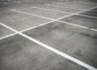 Closeup of a concrete parking lot.